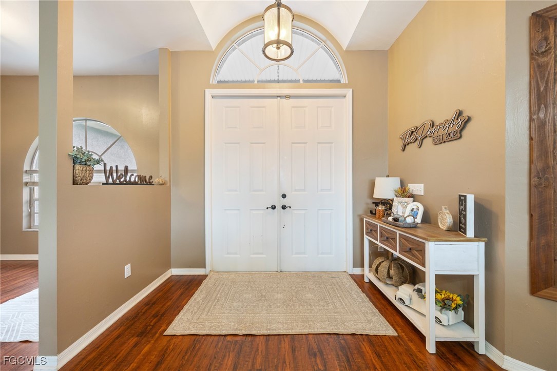 914 Sawgrass Street Clewiston, FL 33440 - Photo 3 of 43 a view of a hallway to a livingroom with furniture and wooden floor