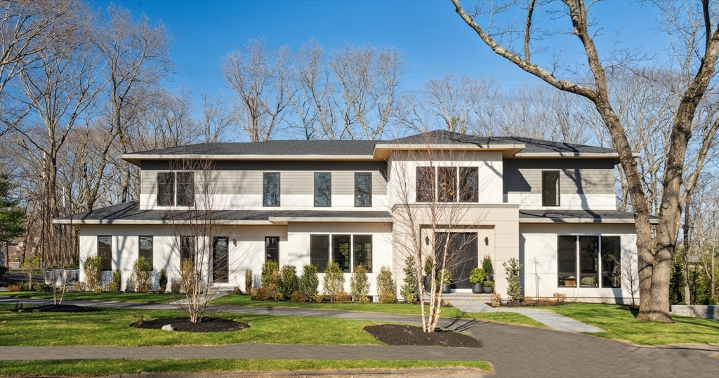 a front view of a residential apartment building with a yard