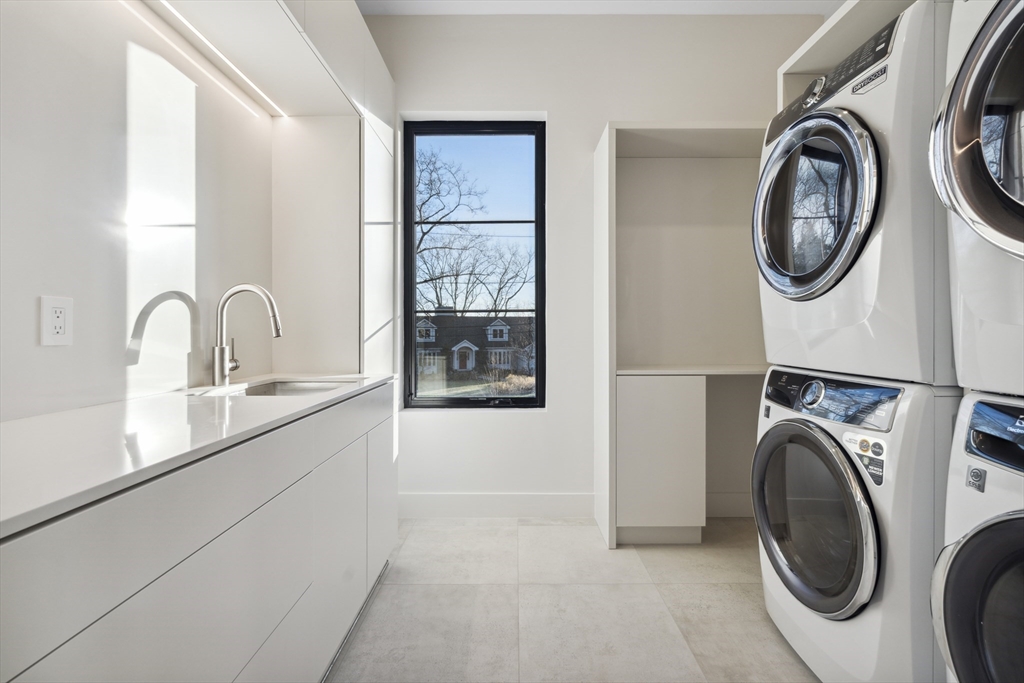 9 Bellevue Road Wellesley, MA 02481 - Photo 28 of 38 a kitchen with a sink a washer and dryer