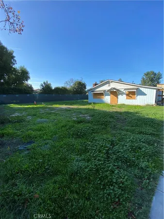 a view of yard with swimming pool and green space