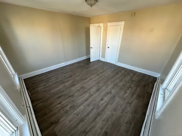 a view of an empty room and wooden floor