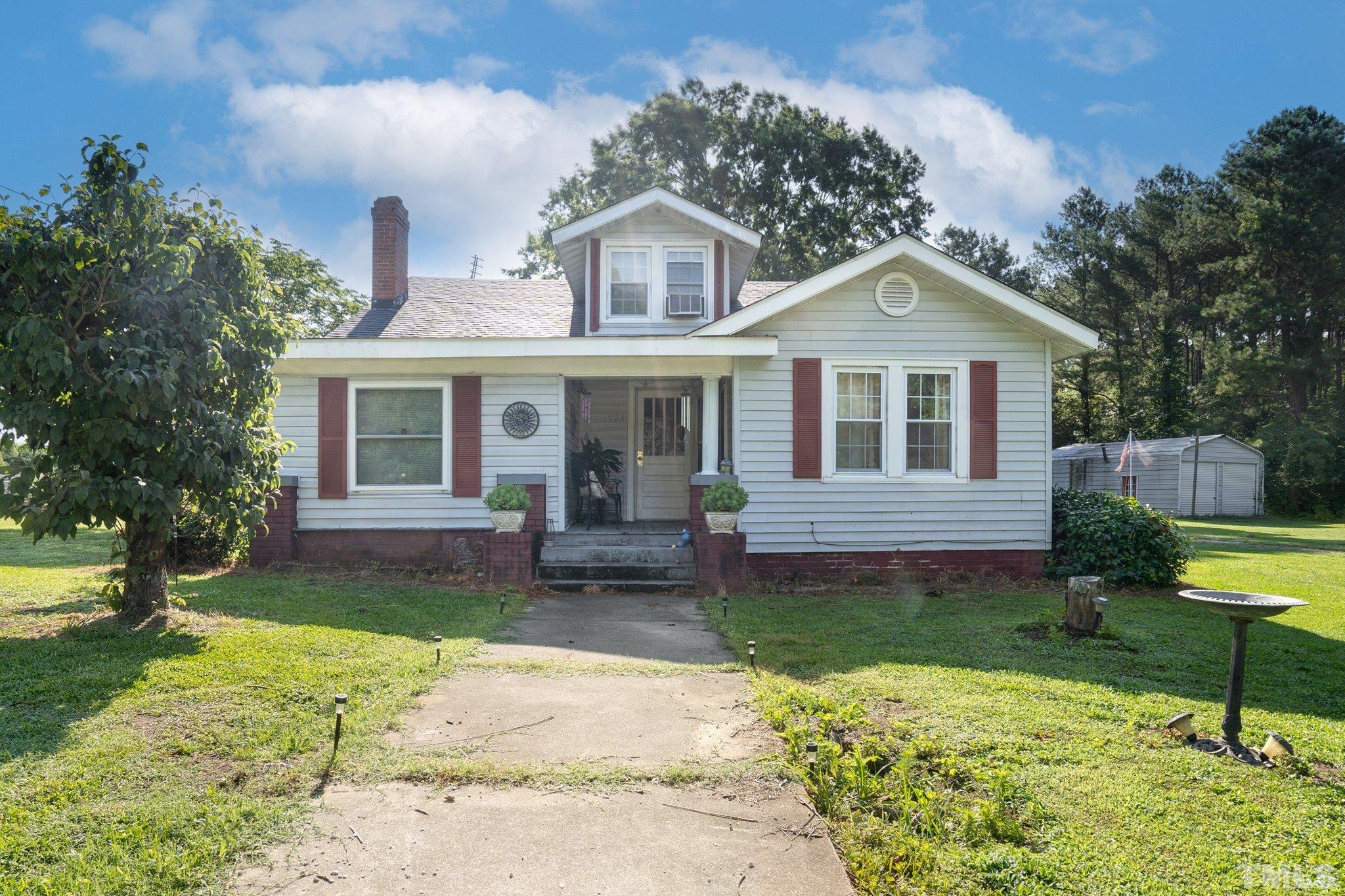 1724 Old Us 64 Spring Spring Hope, NC 27882 - Photo 1 of 23 a front view of a house with garden