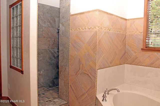 a bathroom with a bathtub and shower