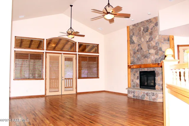 a view of a livingroom with a ceiling fan and window