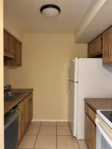a kitchen with a refrigerator and a sink