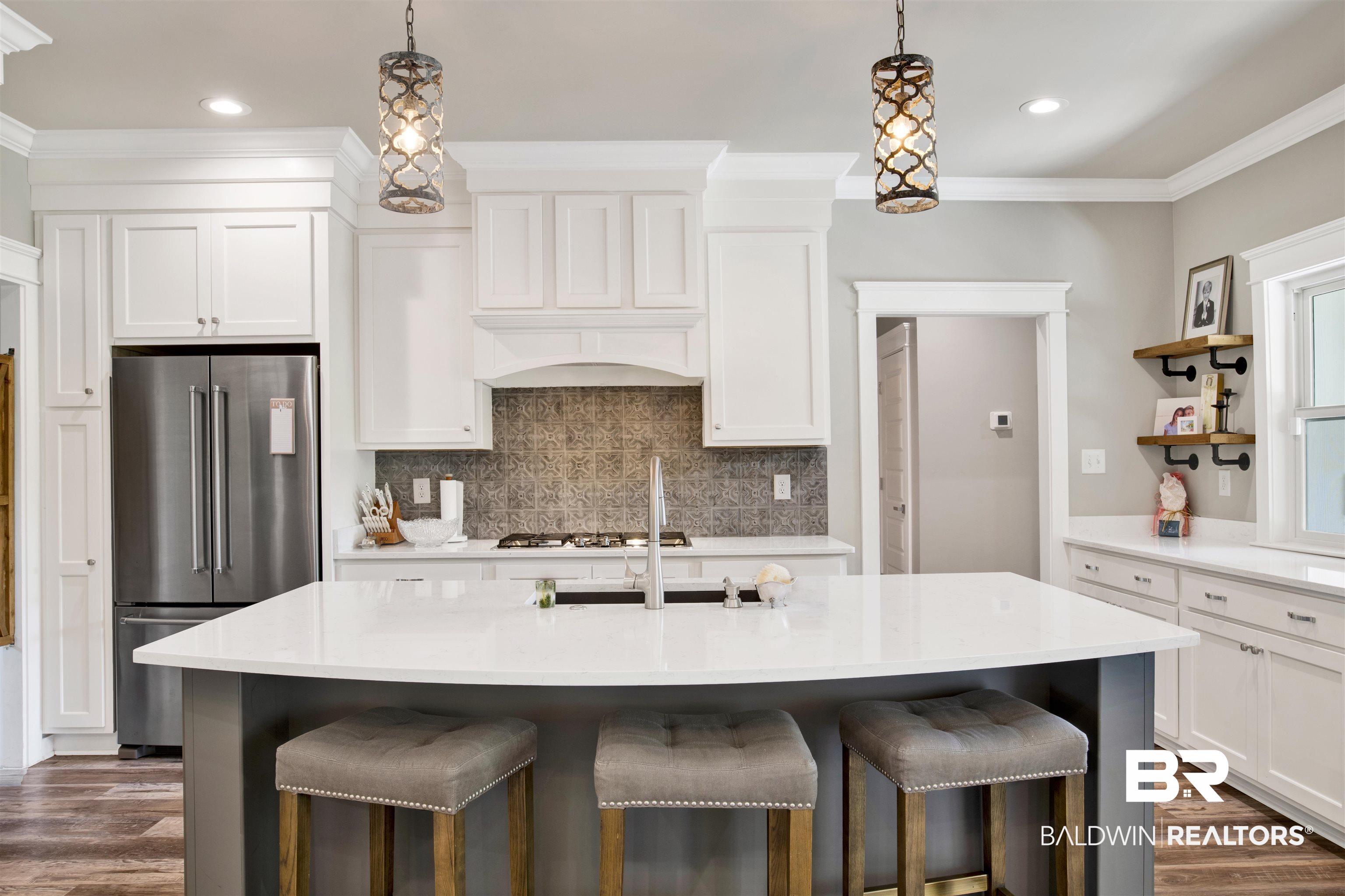 21621 Veranda Boulevard Fairhope, AL 36532 - Photo 31 of 51 Kitchen with high end refrigerator, open shelves, a kitchen breakfast bar, and tasteful backsplash
