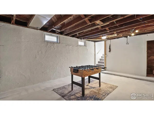 a black and white photo of a room with gym equipment