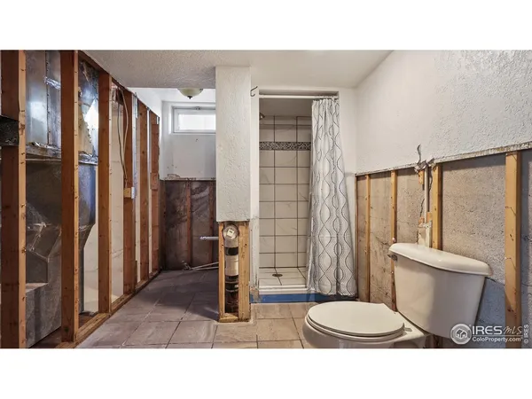 a bathroom with a toilet a sink and shower