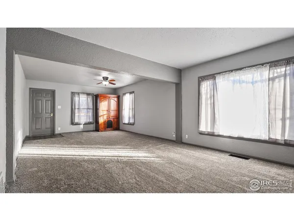 a living room with furniture and windows