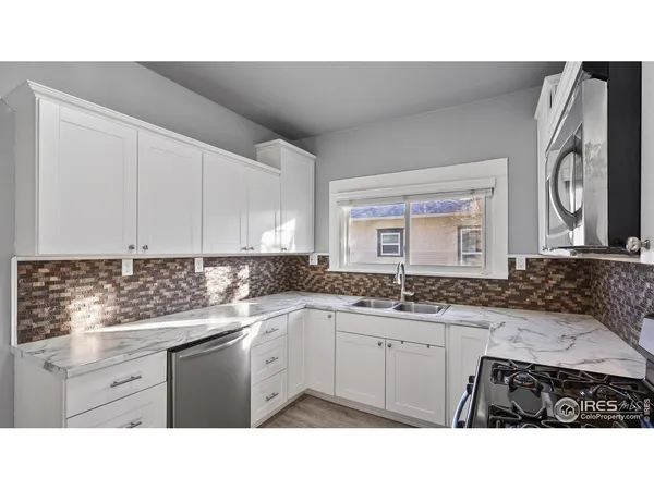 a kitchen with a sink cabinets and window