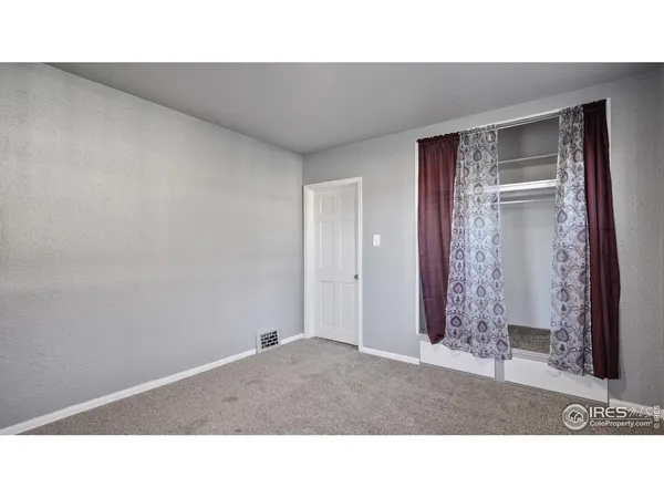 a black and white photo of a bedroom