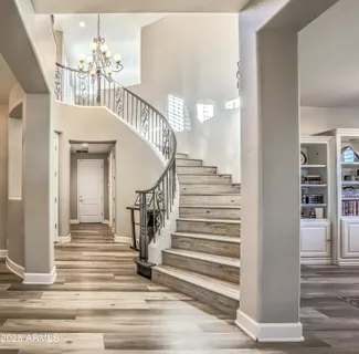 a view of entryway and hall with wooden floor