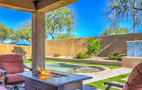 a view of a backyard with swimming pool