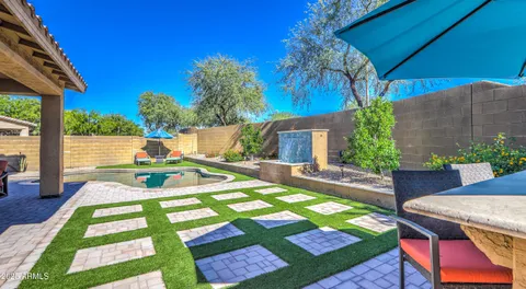 a view of a house with swimming pool and sitting area