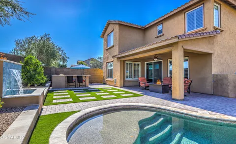 a view of a backyard with swimming pool