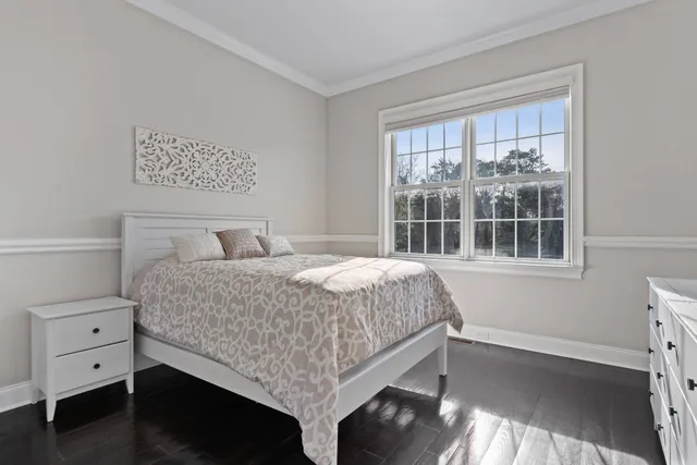 a bedroom with a large bed and a window