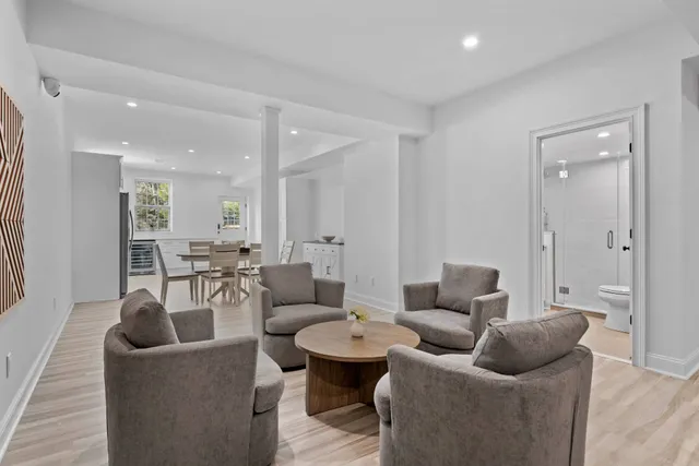 a living room with furniture and a view of bathroom