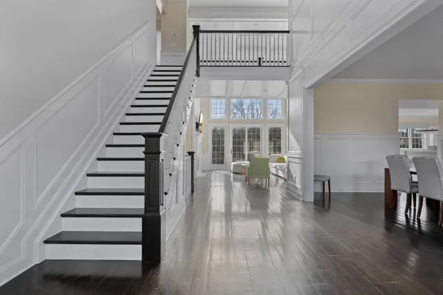 a view of entryway and hall with wooden floor