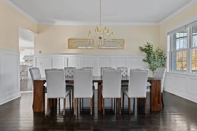 a view of a dining room with furniture wooden floor and chandelier