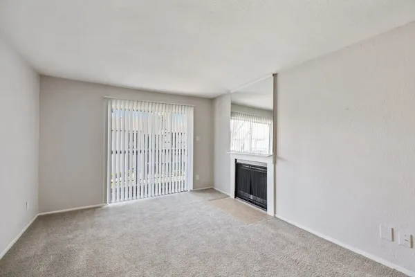 a view of an empty room with a fireplace