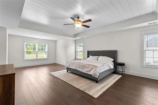 a spacious bedroom with a bed and a window