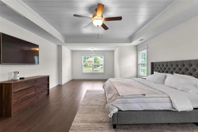 a bedroom with a large bed and a flat screen tv