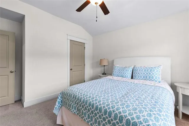 a bedroom with a bed and painting on the wall