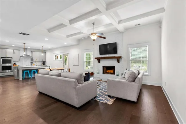 a living room with furniture a fireplace and a flat screen tv