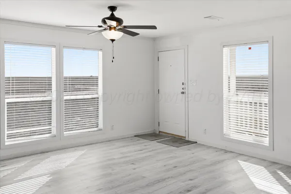 a view of an empty room with a window