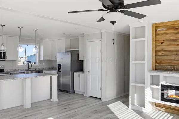 a kitchen with granite countertop a refrigerator and a sink