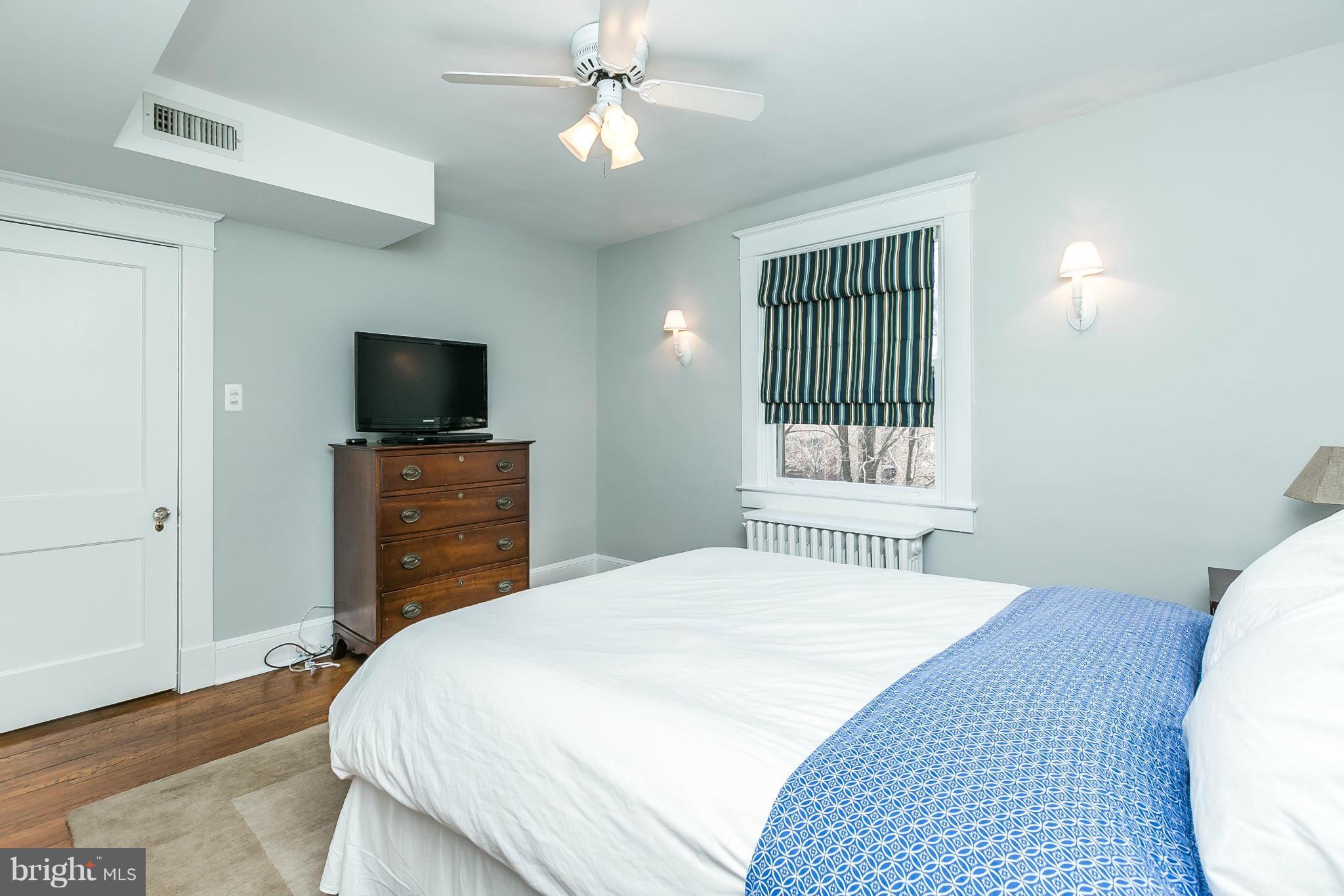 5007 Falls Rd Terrace Baltimore, MD 21210 - Photo 16 of 30 a bedroom with a bed and a flat screen tv