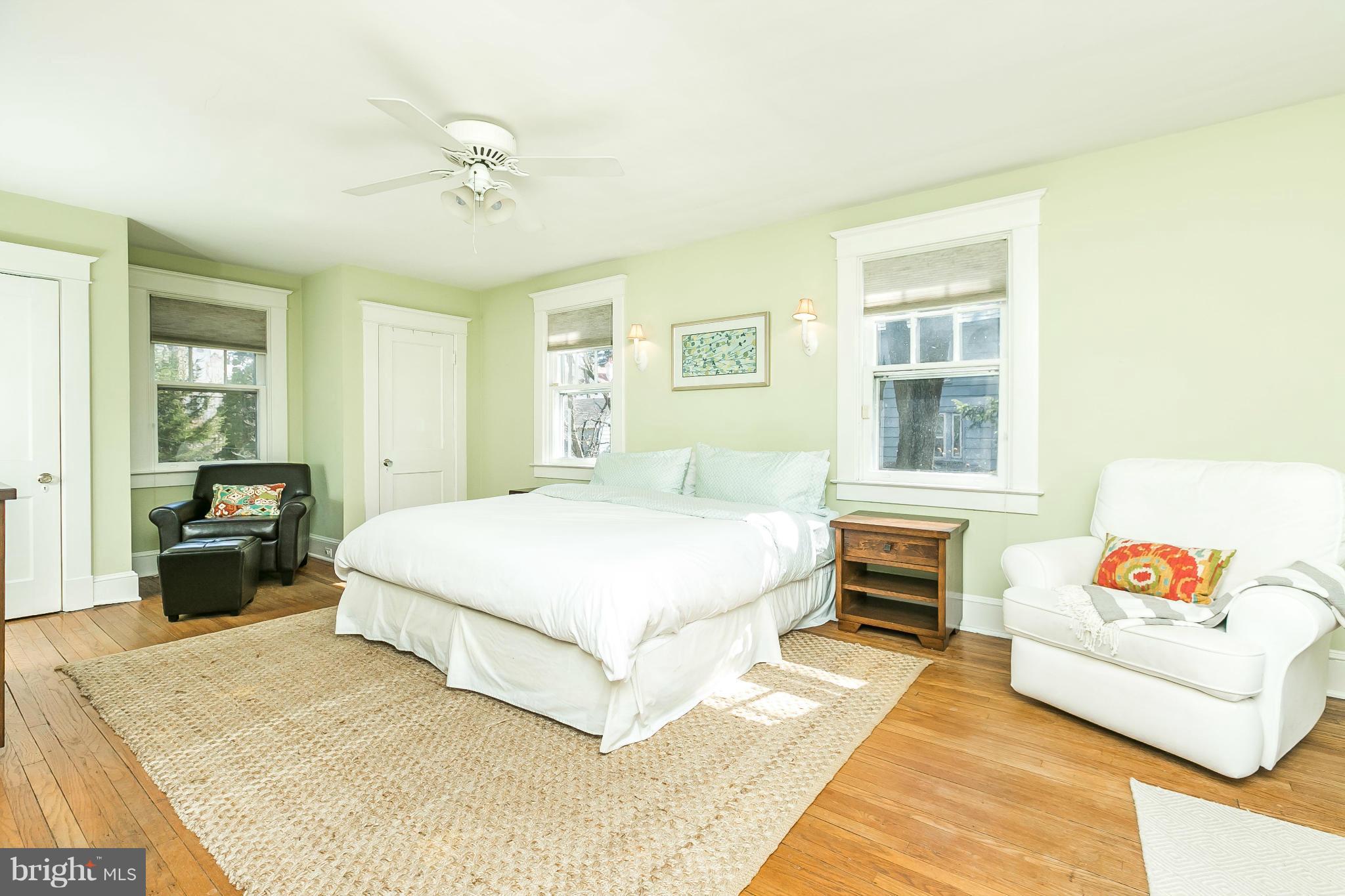 5007 Falls Rd Terrace Baltimore, MD 21210 - Photo 19 of 30 a spacious bedroom with a bed a dresser and a window