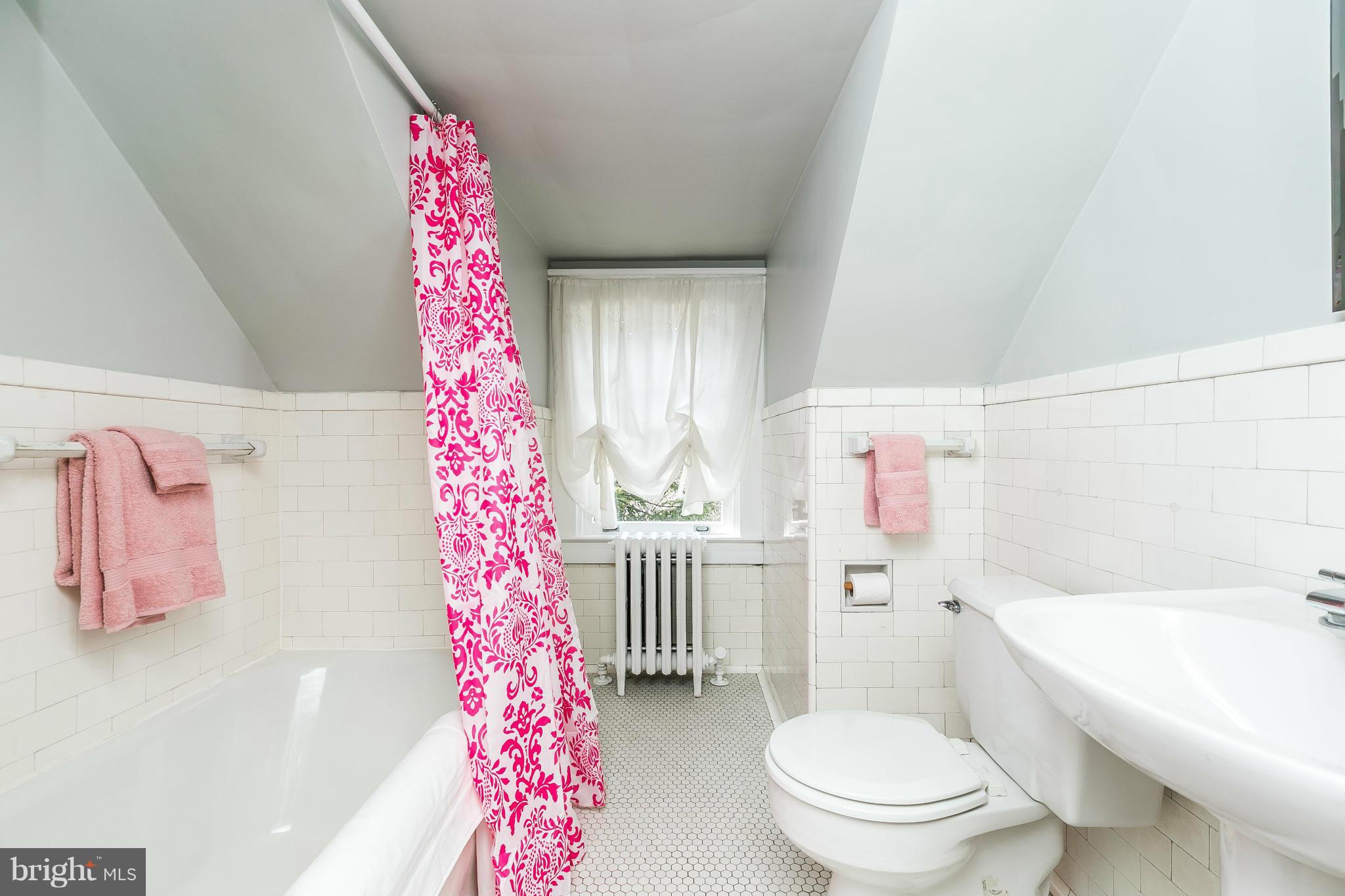 5007 Falls Rd Terrace Baltimore, MD 21210 - Photo 22 of 30 a bathroom with a bathtub sink mirror vanity and toilet