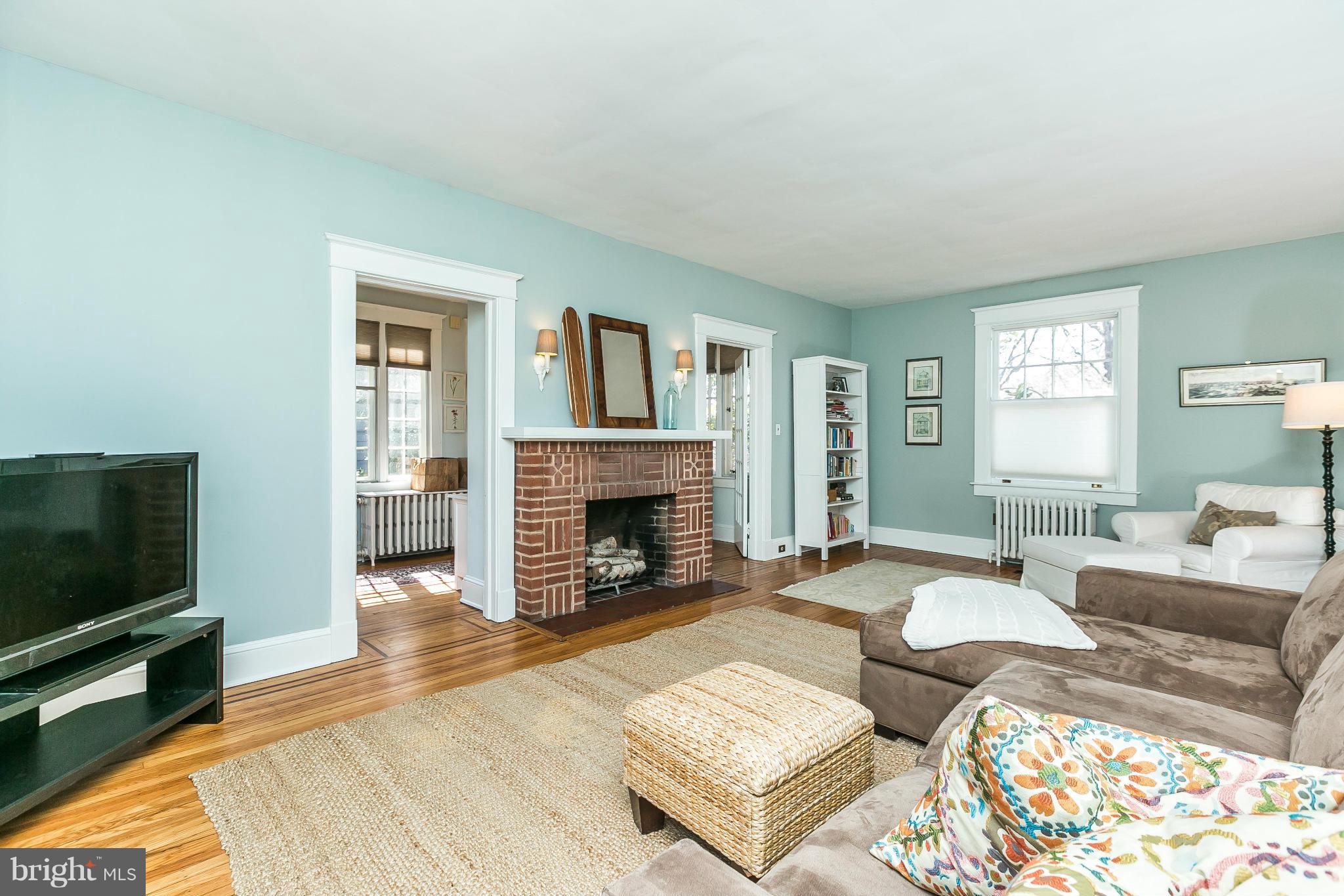 5007 Falls Rd Terrace Baltimore, MD 21210 - Photo 7 of 30 a living room with furniture a fireplace and a flat screen tv