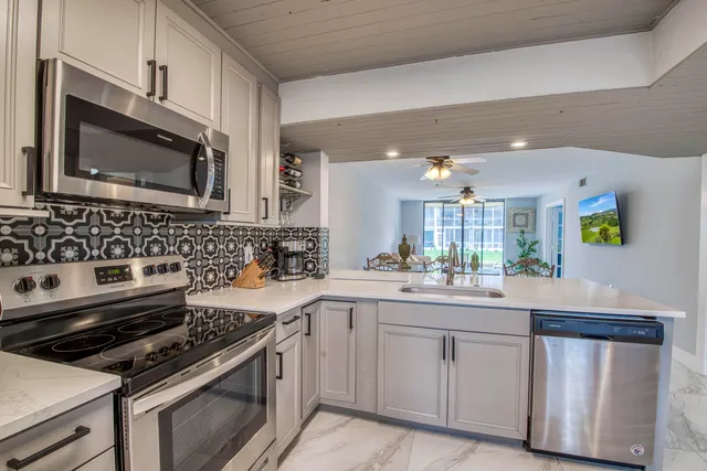 a kitchen with a sink stove and microwave