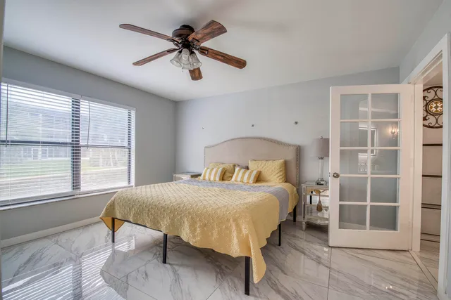 a bedroom with a bed and a window