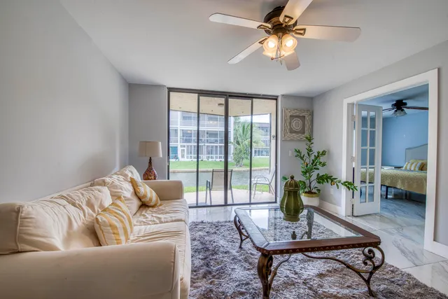 a living room with furniture and a potted plant