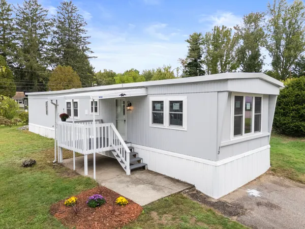 a view of a house with backyard and porch