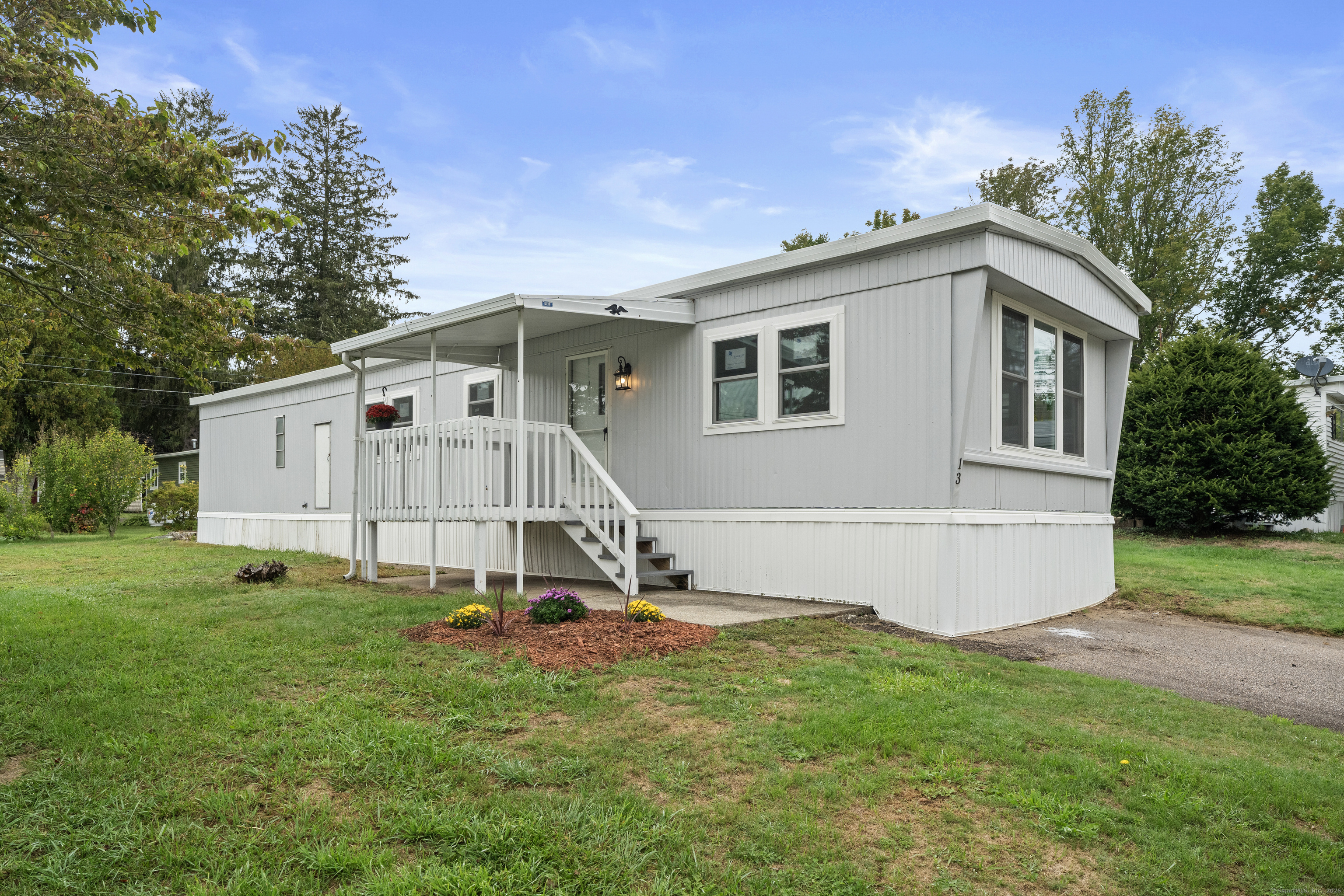 80 Sheldon Road Griswold, CT 06351 - Photo 19 of 24 a view of a white house with a big yard and large trees