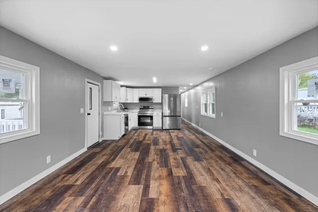 a view of kitchen with wooden floor and window
