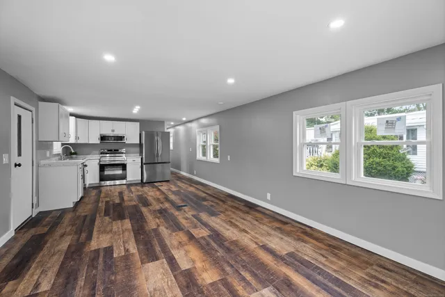 a view of kitchen with wooden floor electronic appliances and window