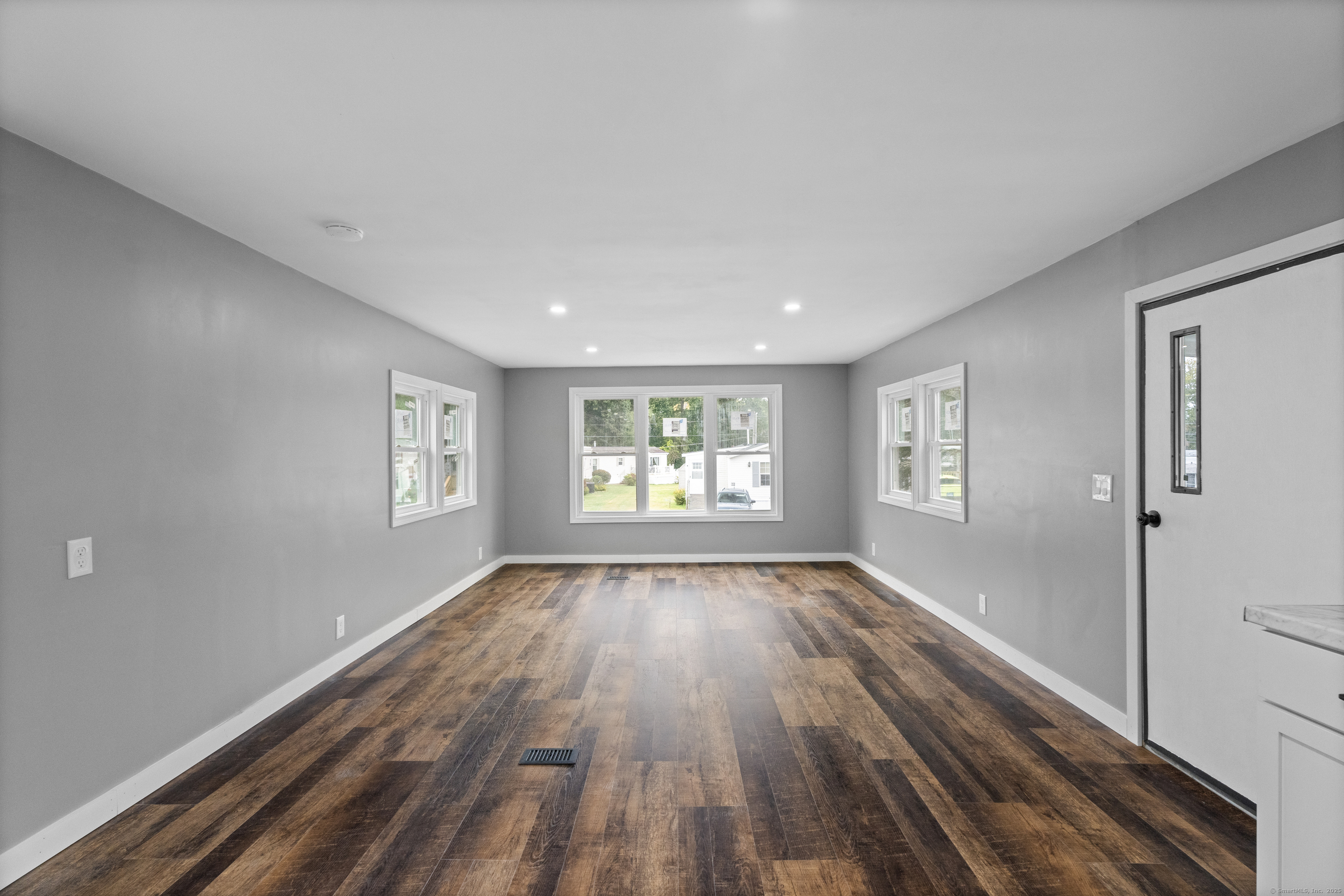 80 Sheldon Road Griswold, CT 06351 - Photo 7 of 24 a view of an empty room and a window and wooden floor
