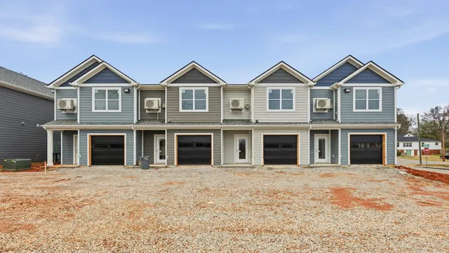 a view of a brick house with large windows