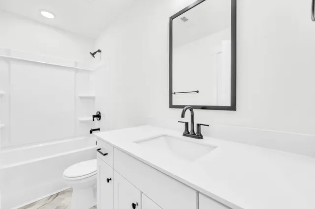 a front view of a residential houses with yard and green space