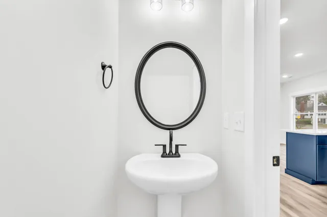 a bathroom with a sink a mirror and a shower