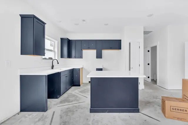 a spacious bathroom with a bathtub sink and mirror