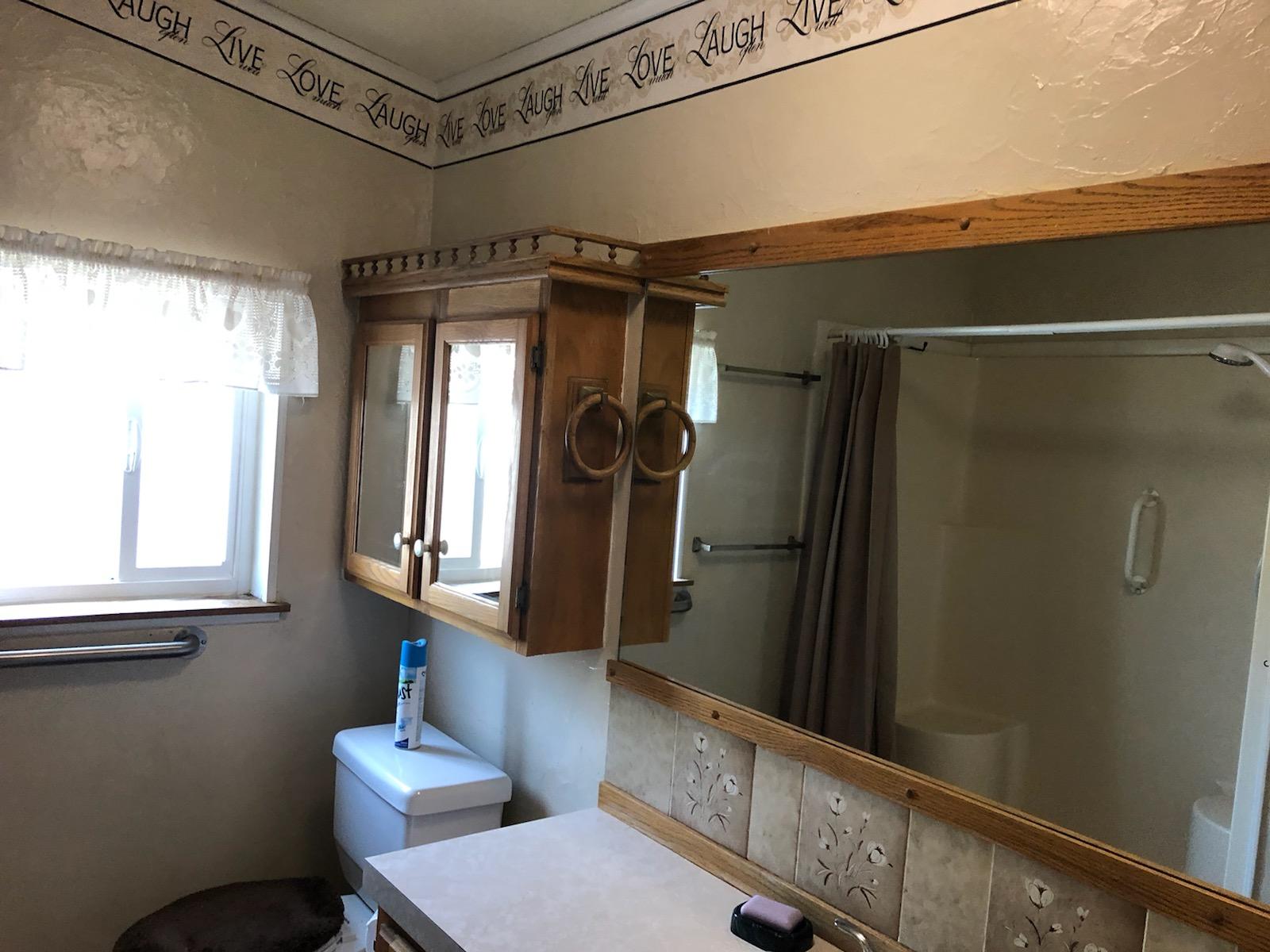 22325 Brent Road Red Bluff, CA 96080 - Photo 14 of 36 a bathroom with a toilet a sink and window