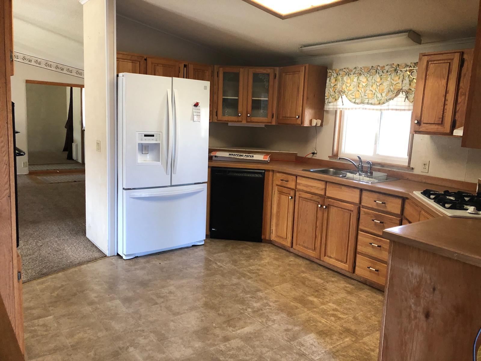 22325 Brent Road Red Bluff, CA 96080 - Photo 5 of 36 a kitchen with a refrigerator sink and cabinets