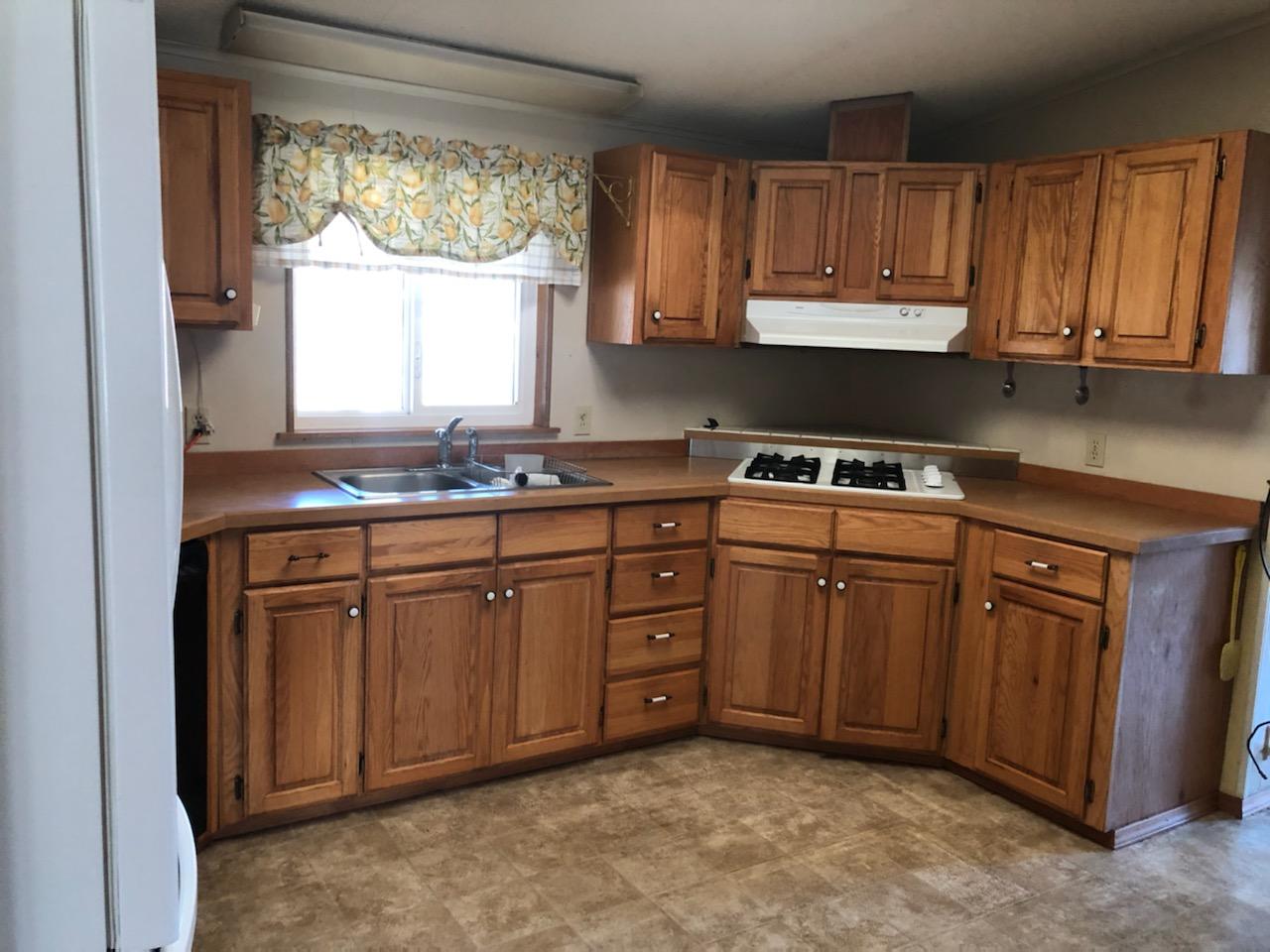 22325 Brent Road Red Bluff, CA 96080 - Photo 6 of 36 a kitchen with stainless steel appliances granite countertop a sink stove and cabinets