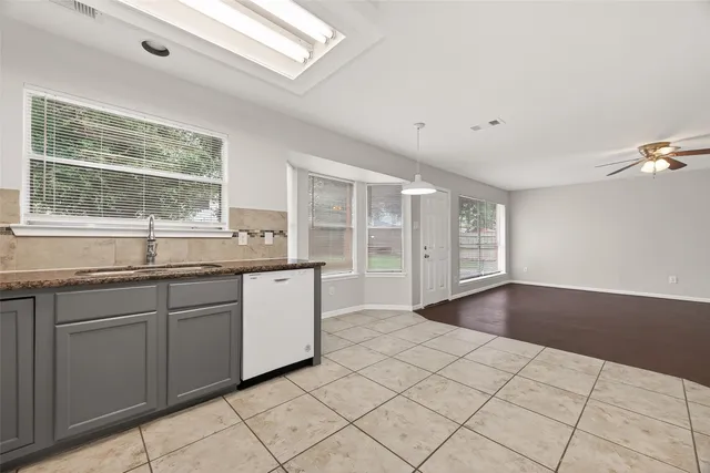 a kitchen with granite countertop a sink and a stove